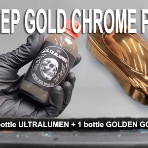 May include: A 2 Step Gold Chrome Pack is displayed. The image shows a bottle of Ultralumen and a golden-colored object. The Ultralumen bottle is held by a gloved hand and has a skull label. The text "2 STEP GOLD CHROME PACK" is at the top.