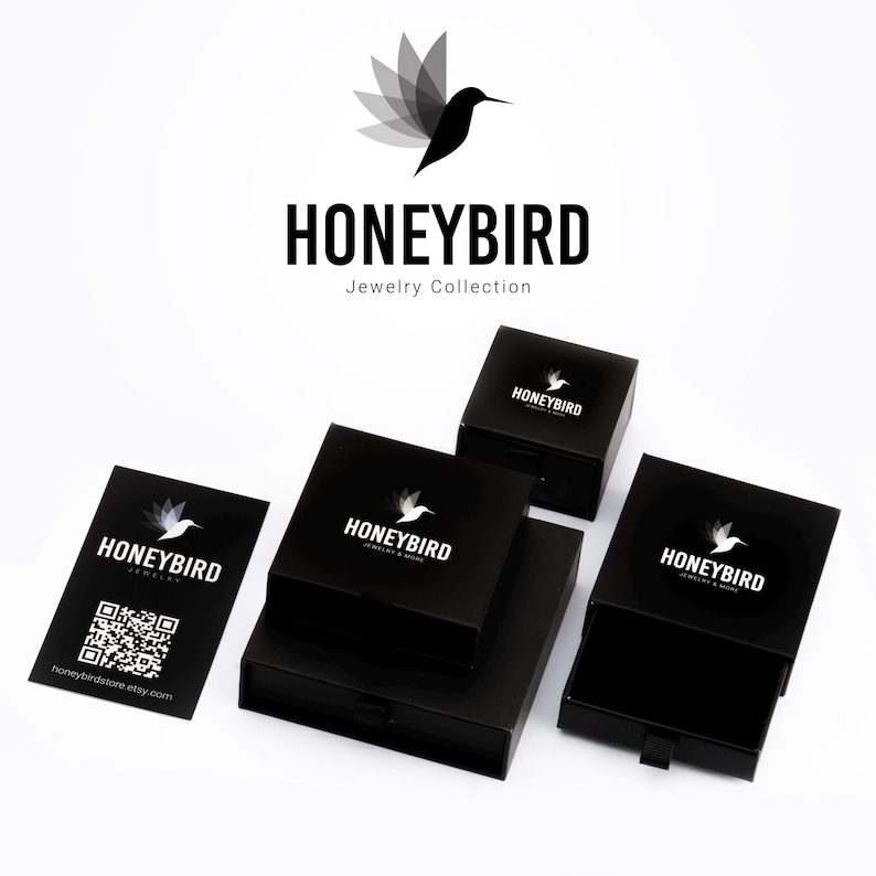 a collection of black jewelry boxes and business cards for a brand called "Honeybird Jewelry Collection".