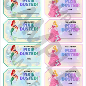 May include: A sheet of eight rectangular gift tags with rounded corners. Four tags feature a mermaid with red hair and a green tail, while four feature a blonde character in a pink gown. Each tag includes the text YOU HAVE BEEN PIXIE DUSTED! and FROM: