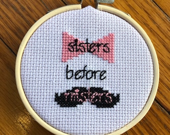 Sisters Before Misters finished cross stitch