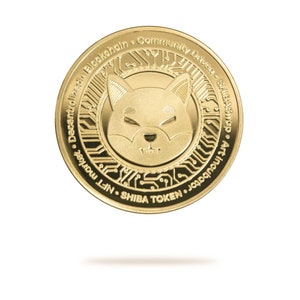 Puede incluir: Moneda de color dorado con la cara de un perro Shiba Inu en el centro. La moneda tiene texto alrededor del borde que dice "Decentralized Blockchain Community Driven ShibaSwap Art in Your Wallet NFT Shiba Token".
