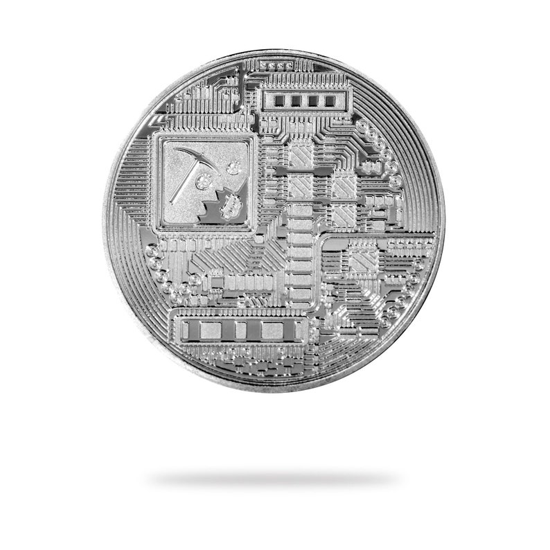 May include: A silver-colored Bitcoin cryptocurrency coin with a circuit board design and a pickaxe and rock graphic in the center.