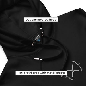 May include: Black hooded sweatshirt with a double-layered hood and flat drawcords with metal aglets. The sweatshirt has a small, gray, stylized logo on the front.