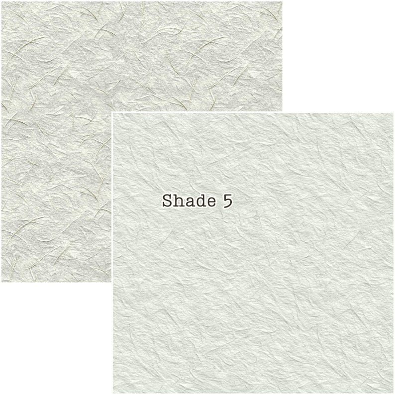 Puede incluir: Dos hojas de papel texturizado blanco roto. Una es rectangular, la otra cuadrada con el texto "Shade 5". El papel tiene un aspecto delicado y fibroso con sutiles variaciones de tono, sugiriendo una calidad artesanal.