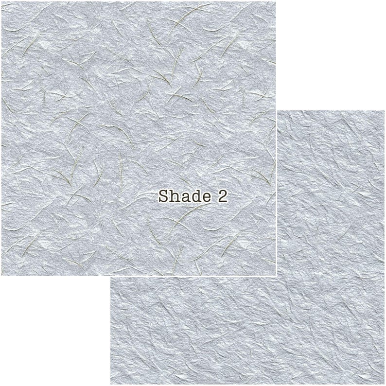 Puede incluir: Papel texturizado gris claro con sutiles fibras verdes y blancas. El papel tiene un aspecto arrugado y el texto "Shade 2" est&aacute; impreso en marr&oacute;n. El papel se muestra en tres tama&ntilde;os diferentes.