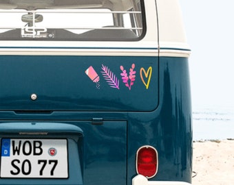 May include: A teal blue vintage van with a license plate that reads "WOB SO 77". The van has a variety of colorful stickers on the back, including a salt shaker, a leaf, a flower, and a heart.