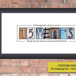 May include: Framed print with the words "15 YEARS" in a unique font, with the text "In Recognition of your service" and "Thank you for all your hard work Matthew!" The print is in a black frame, set against a brick wall.
