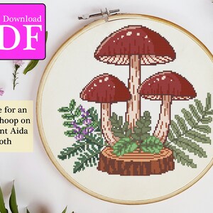 May include: Cross stitch pattern for three red mushrooms with white spots growing from a brown tree stump surrounded by green leaves. The pattern is designed for an 8-inch hoop on 18-count Aida cloth. Instant Download PDF.
