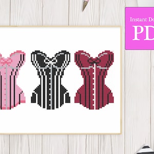 May include: Three cross-stitch patterns of corsets in pink, black, and red with white accents.  The patterns are for a craft project.