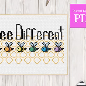 Puede incluir: Patrón de punto de cruz con el texto "Bee Different" y una fila de abejas coloridas en un patrón de panal.