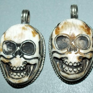 Two Bone Skull Amulets Pendants with Metal Mounting Nepal