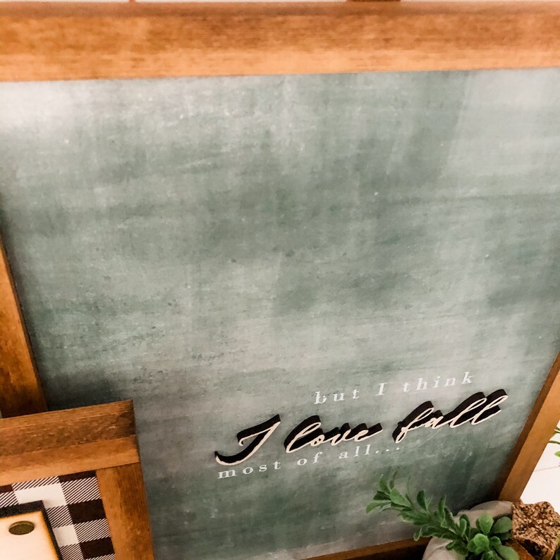 May include: A framed chalkboard sign with a green background and white text that reads "but I think I love fall most of all..."