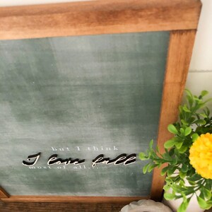 May include: A framed chalkboard sign with a green background and white text that reads "but I think I love fall most of all."