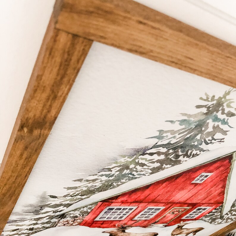 May include: A watercolor painting of a red cabin in a snowy forest. The cabin has a white roof and a brown door. There are two deer in the foreground.
