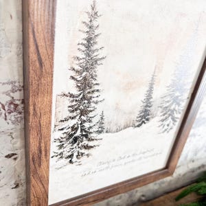 May include: A framed print of a wintery forest scene with snow-covered trees and a quote about peace. The quote reads "Peace is God in the heart, and so it will govern all your thoughts and so settle..."