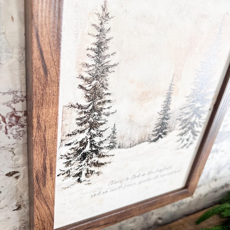 May include: A framed print of a wintery forest scene with snow-covered trees and a quote about peace. The quote reads "Peace is God in the heart, and so it will govern all your thoughts and so settle..."