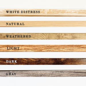 May include: Six wood samples showing different wood finishes: white distress, natural, weathered, light, dark, and gray.