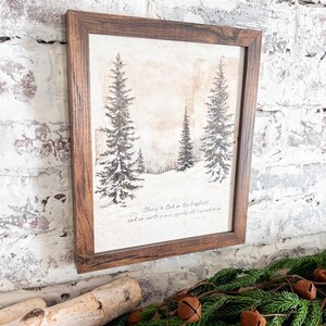 May include: A framed print with a wintery scene of snow-covered trees. The print features the text "Glory to God in the highest, and on earth peace, goodwill toward men."