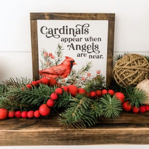 May include: A wooden sign with a watercolor painting of a cardinal bird and the text "Cardinals appear when Angels are near."
