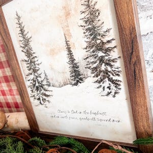 May include: A framed print with a wintery scene of snow-covered trees and the text "Glory to God in the highest, and on earth peace, goodwill toward men. Luke 2:14"