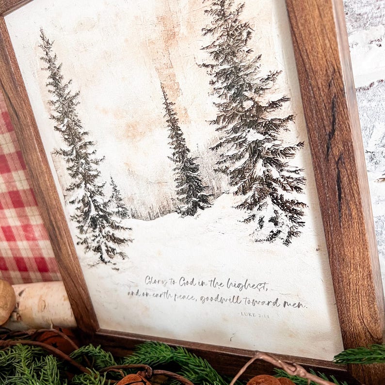 May include: A framed print with a wintery scene of snow-covered trees and the text "Glory to God in the highest, and on earth peace, goodwill toward men. Luke 2:14"