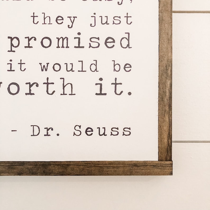 May include: A framed print with a white background and a black and white quote from Dr. Seuss that reads "It's not easy, they just promised it would be worth it."