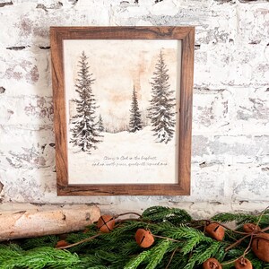 May include: A framed print with a wintery forest scene and a quote from Luke 2:14: "Glory to God in the highest, and on earth peace, goodwill toward men."