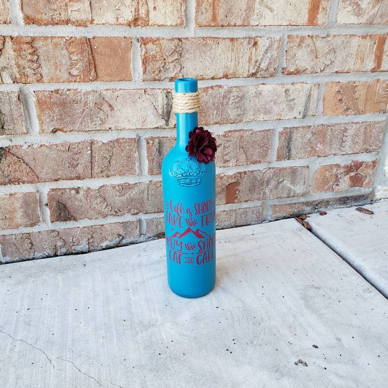 Custom painted wine bottle decor made from repurposed bottles perfect for wedding decor.