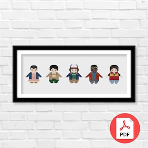 May include: A black framed picture with a white background featuring five pixelated characters from the show Stranger Things. The characters are wearing different colored clothing and are standing in a row.