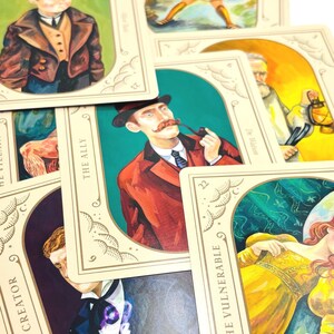 May include: A set of three ceramic mugs with a speckled, matte finish. The mugs are in shades of cream, light gray, and dark gray. Each mug has a simple, minimalist design and a rounded handle. The mugs are stacked on top of each other.