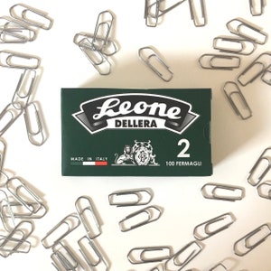 May include: A green box of silver paper clips with the brand name "Leone Dellera" and the text "2 100 Fermagli" printed on the front. Made in Italy.