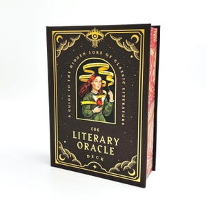 May include: A dark brown book with gold accents and the title "The Literary Oracle Deck." The cover features an illustration of a woman and the text "A Guide to the Hidden Lore of Classic Literature."