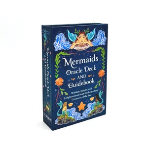 May include: A navy blue oracle deck and guidebook titled "Mermaids Oracle Deck AND Guidebook." The box features illustrations of mermaids, sea creatures, and floral accents. The text reads "Wisdom, Insight, and Enlightenment from the Legendary Creatures of the Sea."