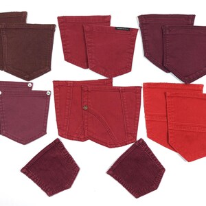 May include: Assortment of ten denim pockets in various shades of red and burgundy. The pockets are all sewn and have a raw edge.