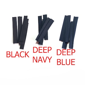 May include: Three groups of narrow fabric strips with stitched edges, labeled as BLACK, DEEP NAVY, and DEEP BLUE. Each group contains several individual pieces of dark-colored textile material arranged in vertical and diagonal orientations.