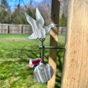 May include: A metal bird silhouette target with a round metal target attached to a wooden post. The bird target is attached to the post with a screw.