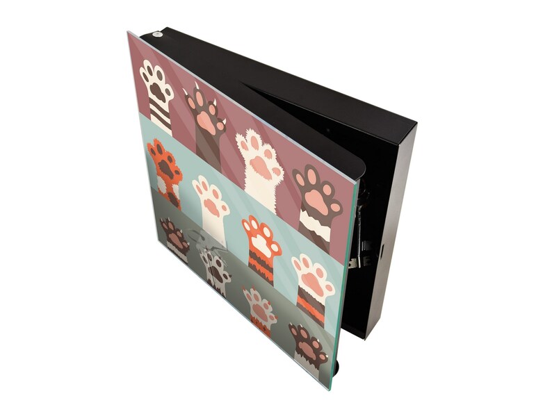 May include: A black box with a hinged lid, the lid is open and reveals a colorful glass panel with a pattern of cat paws in orange, white, and brown on a blue, pink, and green background.