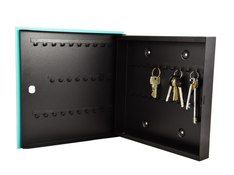 May include: A black metal key holder with a turquoise door. The key holder has multiple hooks for hanging keys. There are several keys hanging on the hooks.