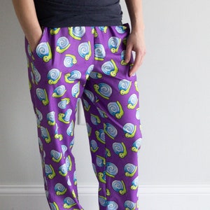 May include: Purple pajama pants with a pattern of yellow and blue snails.