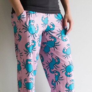 May include: Pink pajama pants with a blue crab pattern.