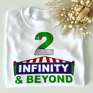 May include: White t-shirt with a green number 2, a red and white striped awning, and the text "INFINITY & BEYOND" in green and purple.