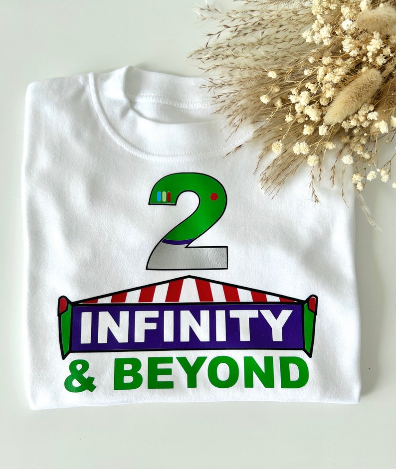 May include: White t-shirt with a green number 2, a red and white striped awning, and the text "INFINITY & BEYOND" in green and purple.