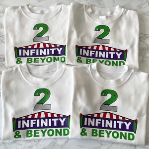 May include: Four white t-shirts with a green number 2, a red and white striped tent, and the text "INFINITY & BEYOND" printed on each shirt.
