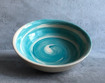 White and turquoise ceramic bowl with spiral decoration