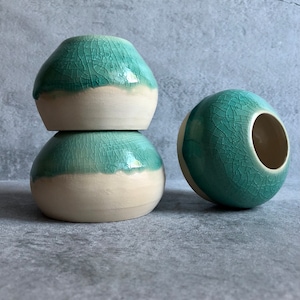 Trio of stackable green ceramic jars with crackle enamel