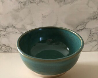 Green stoneware bowl with turquoise shades