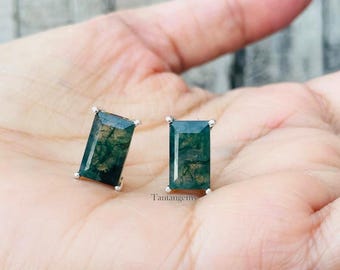 May include: A pair of silver stud earrings with rectangular green moss agate stones.