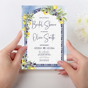 May include: A bridal shower invitation with a watercolor design. The invitation features a blue and white border with lemons and olives. The text reads "Join us for a Bridal Shower to Honor Olivia Smith" with the date and time.