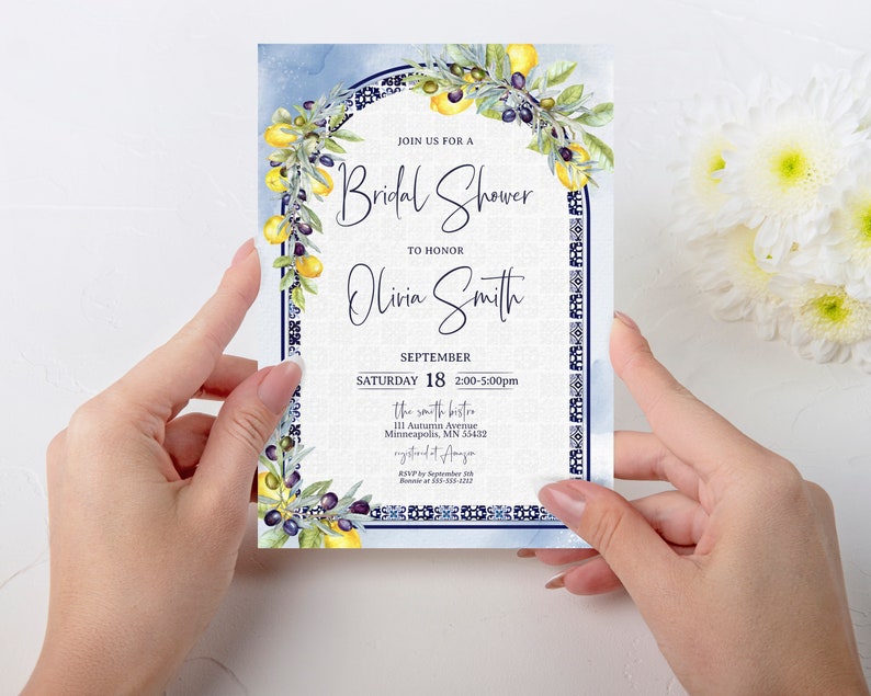 May include: A bridal shower invitation with a watercolor design. The invitation features a blue and white border with lemons and olives. The text reads "Join us for a Bridal Shower to Honor Olivia Smith" with the date and time.