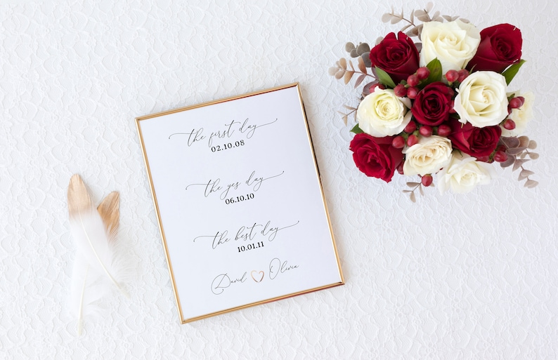 May include: A white framed print with gold trim featuring the text "the first day 02.10.08", "the yes day 06.10.10", and "the best day 10.01.11" with the names "David & Olivia" at the bottom.